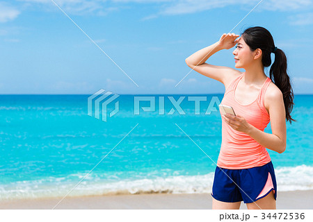 pretty elegant fitness woman standing on beach pretty elegant fitness woman standing on beach 34472536