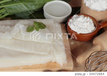 Making rice noodle flat on wood background. 34472664