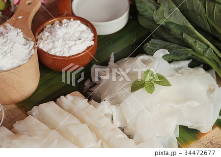 Making rice noodle flat on wood background. 34472677