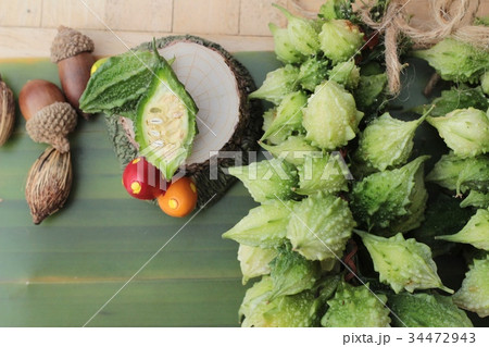 Bitter melon and sliced on wood background. Bitter melon and sliced on wood background. 34472943