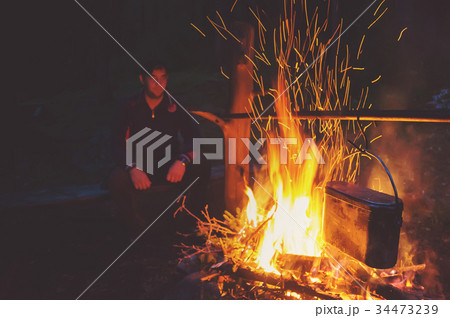 Hiking tourist have a rest in his camp Hiking tourist have a rest in his camp 34473239