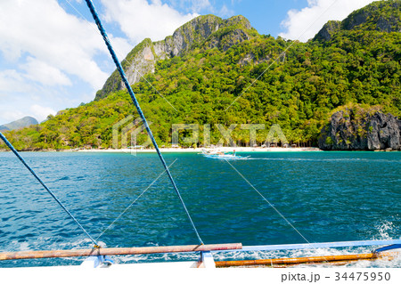 view of the island hill from the prow of a boat 34475950