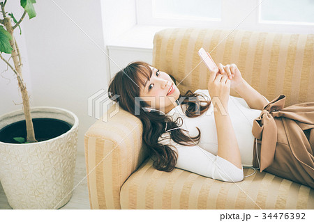 部屋で音楽を聞く女性 部屋で音楽を聞く女性 34476392