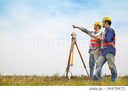 Surveyor engineer making measure with partner 34476472