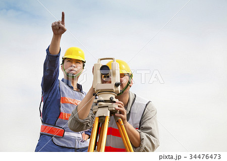 Surveyor engineer making measure with partne 34476473