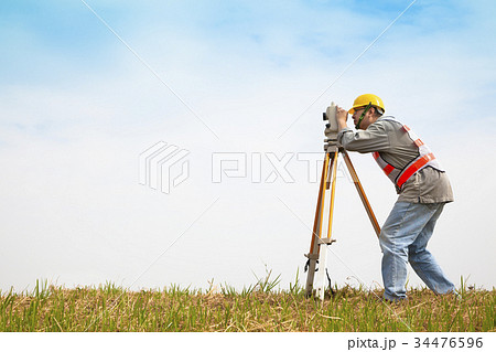 Surveyor engineer making measure on the field Surveyor engineer making measure on the field 34476596