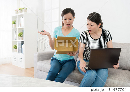 young pretty girl showing empty parcel box young pretty girl showing empty parcel box 34477704