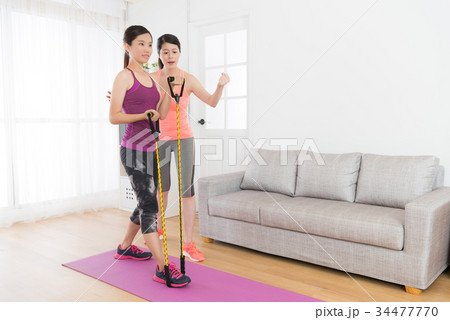 healthy slim girl student using resistance band healthy slim girl student using resistance band 34477770
