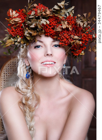 Beautiful girl with rowan wreath on her head Beautiful girl with rowan wreath on her head 34479467