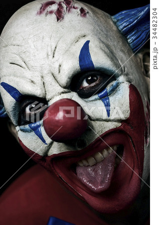 scary evil clown taking out his tongue scary evil clown taking out his tongue 34482304