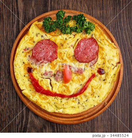 Funny omelet with sausage. Smile Funny omelet with sausage. Smile 34485524