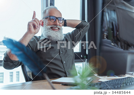 Joyful adult author working at desk 34485644