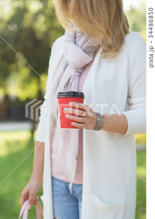 Women with coffe to go. 34486850