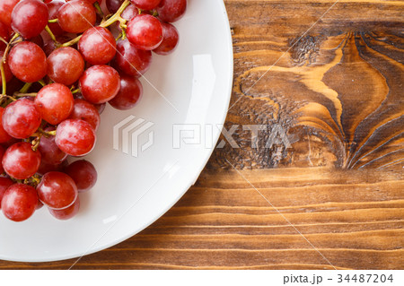 Red grape on wooden table 34487204
