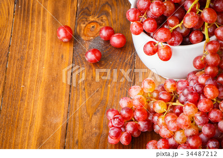 Red grape on wooden table Red grape on wooden table 34487212