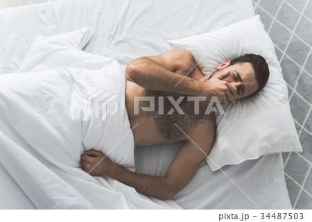 Exhausted male person wants to have a nap 34487503