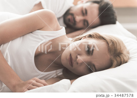 Anxious girl cannot sleep near her husband in Anxious girl cannot sleep near her husband in 34487578