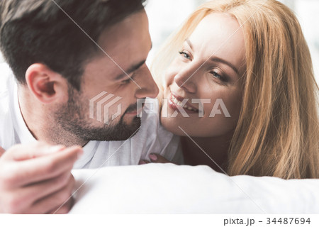 Joyful loving couple relaxing in bedroom Joyful loving couple relaxing in bedroom 34487694