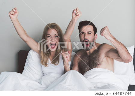 Excited couple celebrating victory of their team 34487744
