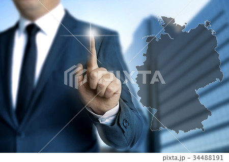 Germany map touchscreen is operated by businessmen 34488191