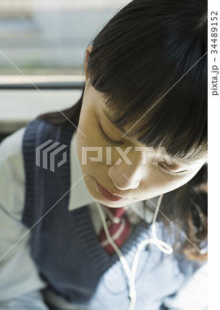 女子高生 通学 電車 居眠りの写真素材