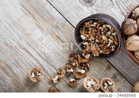 chopped walnuts on a wooden background chopped walnuts on a wooden background 34489568