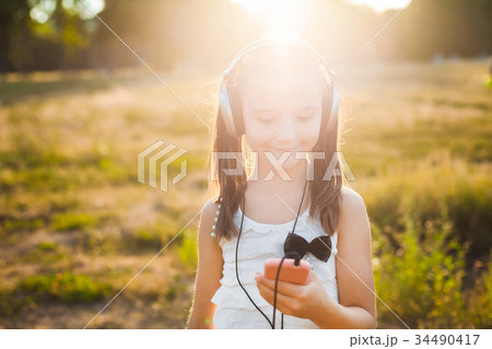 sweet girl using mobile telephone sweet girl using mobile telephone 34490417