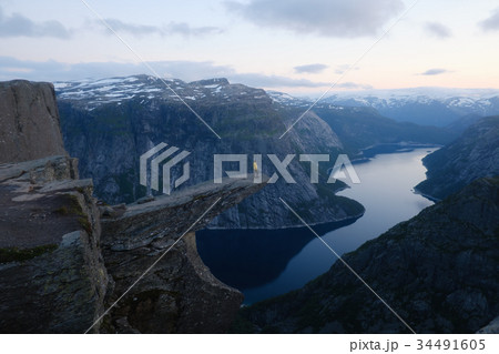 Alone tourist on Trolltunga rock Alone tourist on Trolltunga rock 34491605
