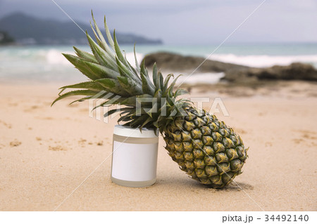 Bottle of sunblock and pineapple Bottle of sunblock and pineapple 34492140