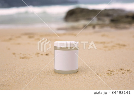 Bottle of sunblock on a sea background 34492141