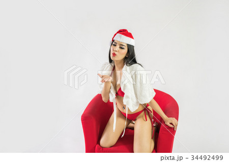 Beautiful happy woman in sexy Santa Claus clothes. Beautiful happy woman in sexy Santa Claus clothes. 34492499