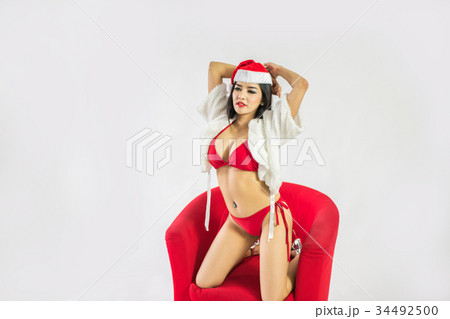 Beautiful happy woman in sexy Santa Claus clothes. 34492500