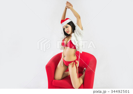 Beautiful happy woman in sexy Santa Claus clothes. Beautiful happy woman in sexy Santa Claus clothes. 34492501