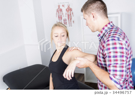 male physio therapist and woman helping patient male physio therapist and woman helping patient 34496757