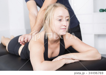 male physio therapist and woman helping patient male physio therapist and woman helping patient 34496769