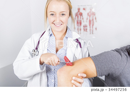 Doctor examining her patient in medical office 34497256