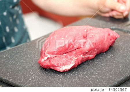 Large piece of red meat ready to cut 34502567