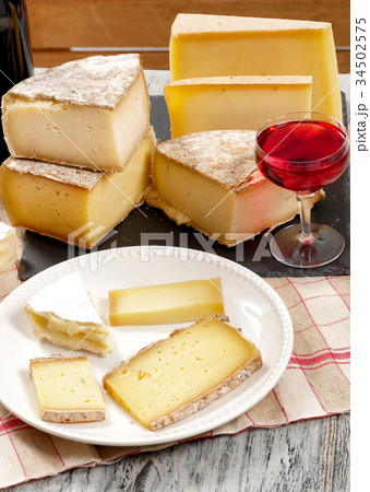 Different french cheeses with a glass of wine 34502575