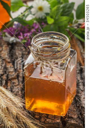 Honey bowl with dipper and flowing honey 34503265