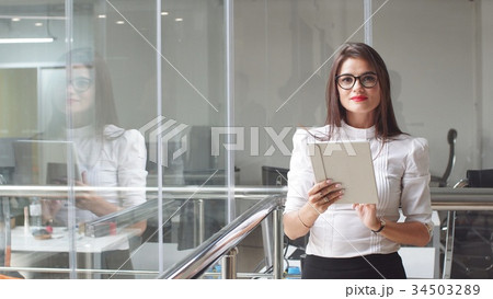 Portrait of sexy business woman in glasses with a Portrait of sexy business woman in glasses with a 34503289