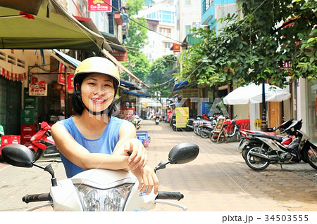 ベトナム ハノイの女性とバイクの写真素材