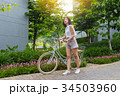 a short hair young woman with her bicycle 34503960