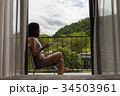 a short hair young woman sitting at the balcony 34503961