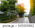 woman riding the bicycle with sunlight 34503962