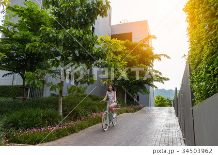 woman riding the bicycle with sunlight 34503962