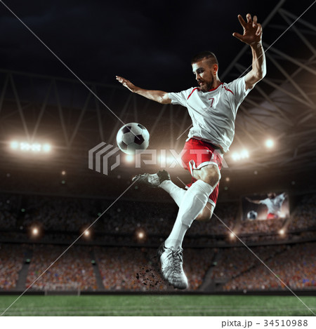 Soccer player performs an action play on a professional stadium 34510988