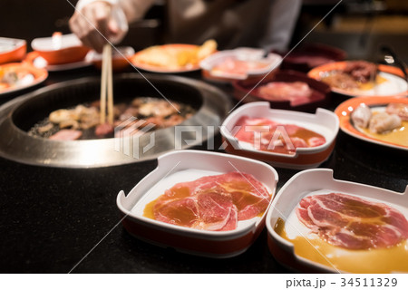Raw beef and pork slice on grille for barbecue Raw beef and pork slice on grille for barbecue 34511329