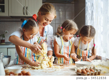 Happy family mother and children twins   bake kneading dough in 34512838