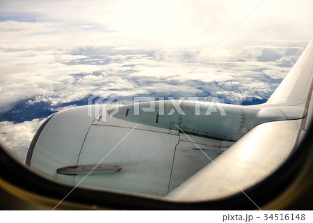 airplane wing against sky and clouds airplane wing against sky and clouds 34516148