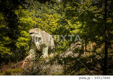 Dinosaur sculpture in a park 34517890